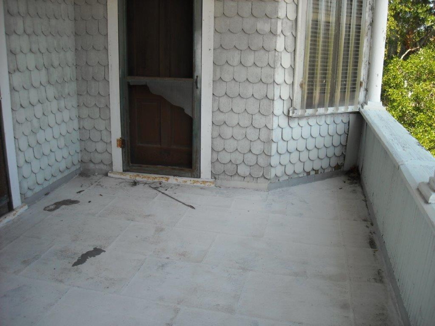 Upstairs porch before restoration.